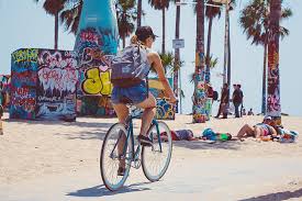 Woman riding bike near beach